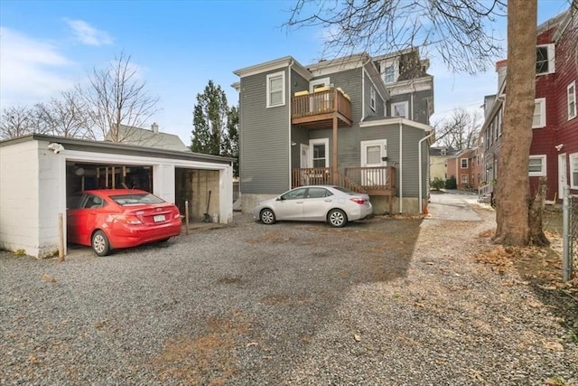 view of front facade with a garage and a balcony