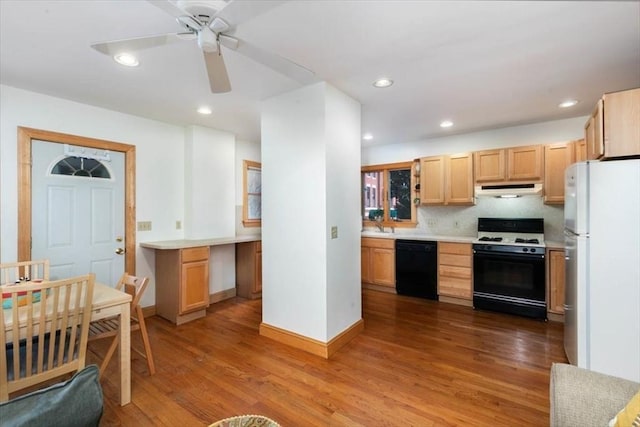 kitchen featuring light brown cabinets, tasteful backsplash, white appliances, and light hardwood / wood-style flooring