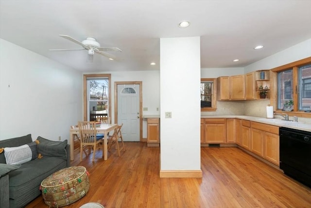 kitchen featuring plenty of natural light, light wood-type flooring, and black dishwasher