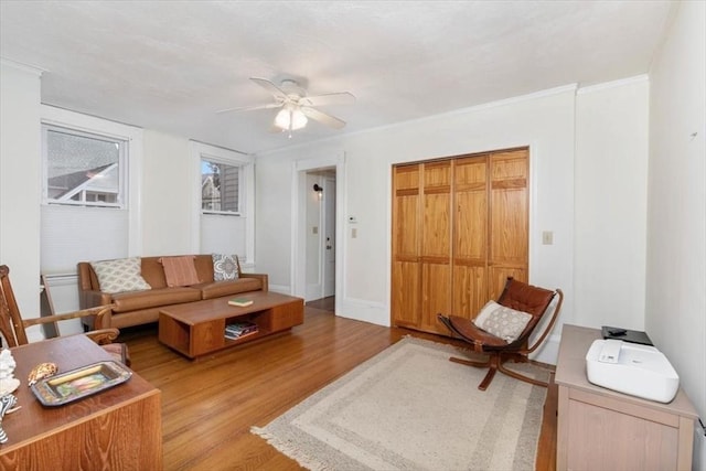 living room with ceiling fan and light hardwood / wood-style flooring