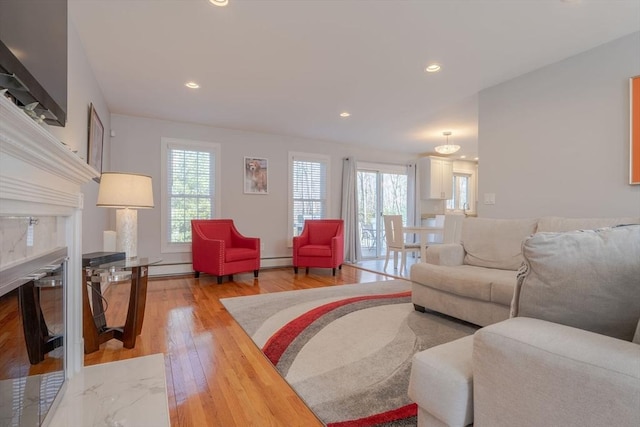 living area featuring recessed lighting, a healthy amount of sunlight, and light wood finished floors