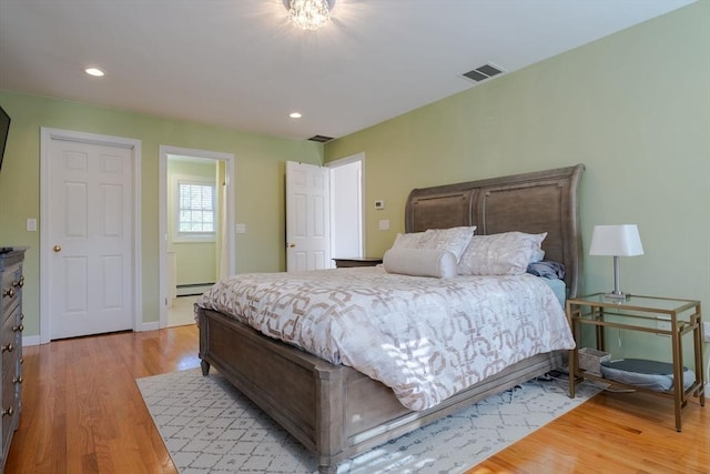 bedroom with visible vents, baseboards, light wood-type flooring, recessed lighting, and a baseboard radiator