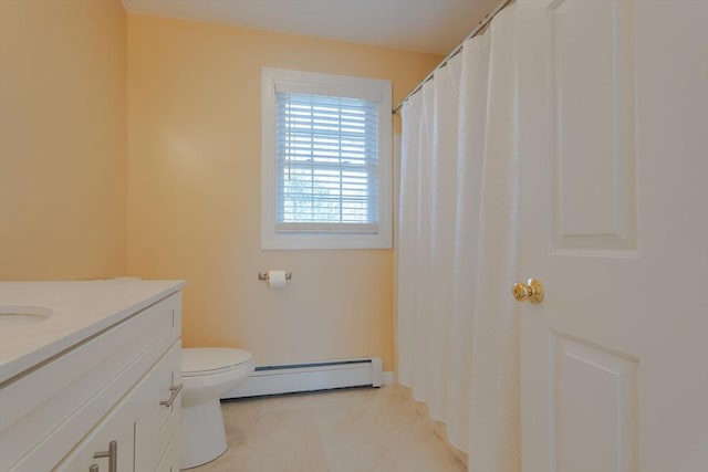 bathroom with toilet, vanity, and a baseboard radiator