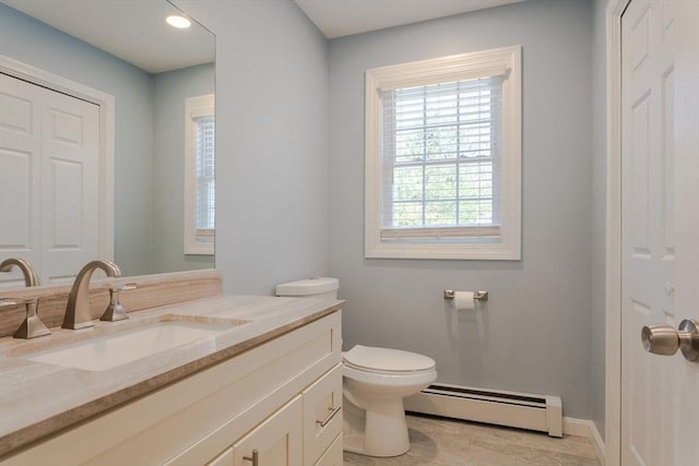 half bathroom featuring baseboards, baseboard heating, vanity, and toilet