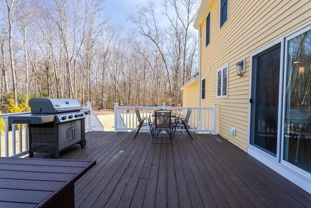 deck featuring a grill and outdoor dining area