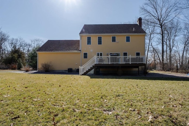 rear view of property featuring stairs, a wooden deck, a yard, and a chimney