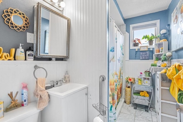 369-371 Mill St, New Bedford, MA 02740 - full bath featuring a shower with curtain, marble finish flooring, vanity, wainscoting, and wooden walls