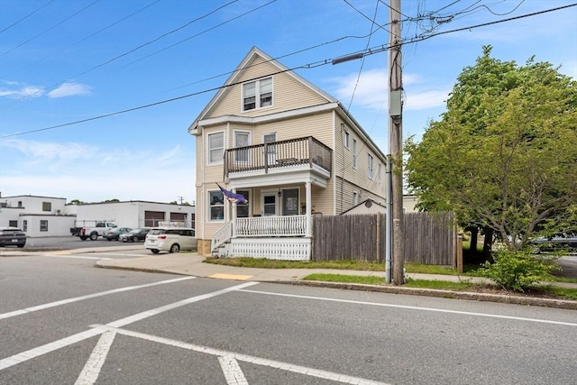 369-371 Mill St, New Bedford, MA 02740 - view of front facade featuring a balcony, a porch, and uncovered parking