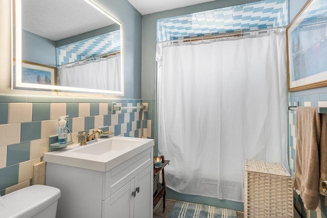 369-371 Mill St, New Bedford, MA 02740 - full bath featuring tile walls, vanity, a shower with shower curtain, toilet, and wainscoting