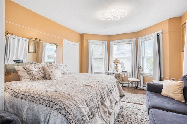 369-371 Mill St, New Bedford, MA 02740 - bedroom featuring light wood-type flooring and a baseboard heating unit