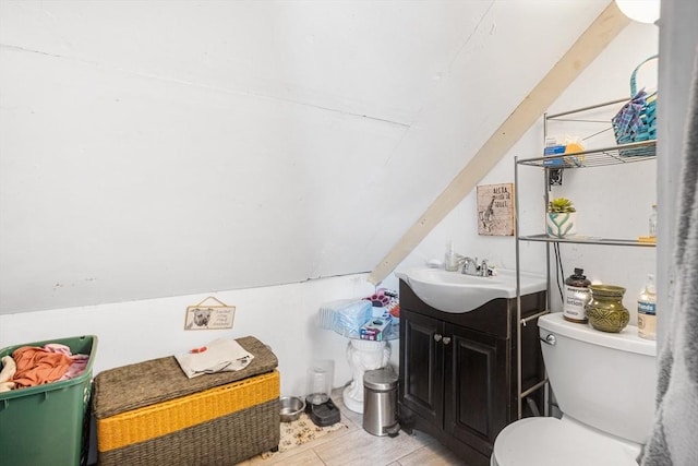 369-371 Mill St, New Bedford, MA 02740 - half bath featuring toilet, vanity, and vaulted ceiling