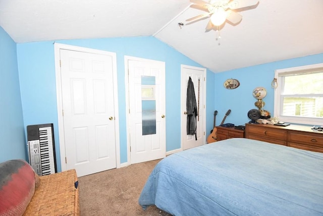 carpeted bedroom featuring lofted ceiling and a ceiling fan