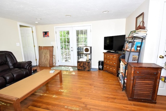 living room with wood finished floors and recessed lighting