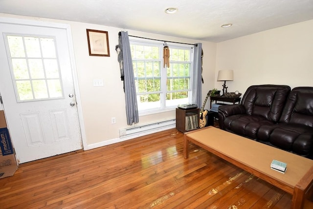 living area with a baseboard radiator, hardwood / wood-style floors, baseboards, and recessed lighting