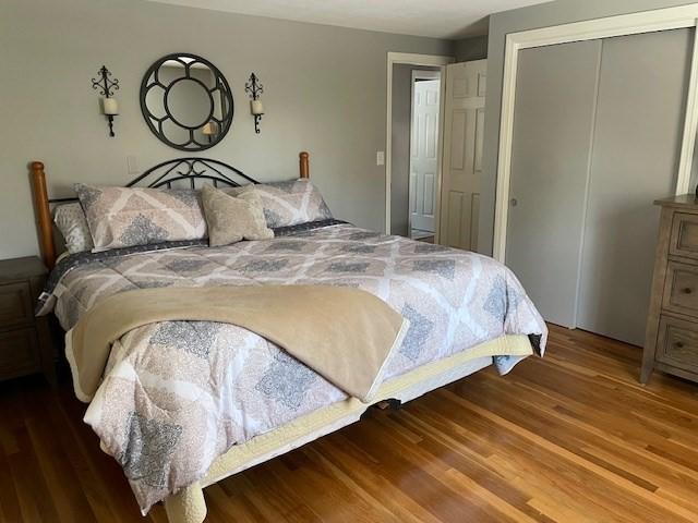 bedroom featuring a closet and wood finished floors