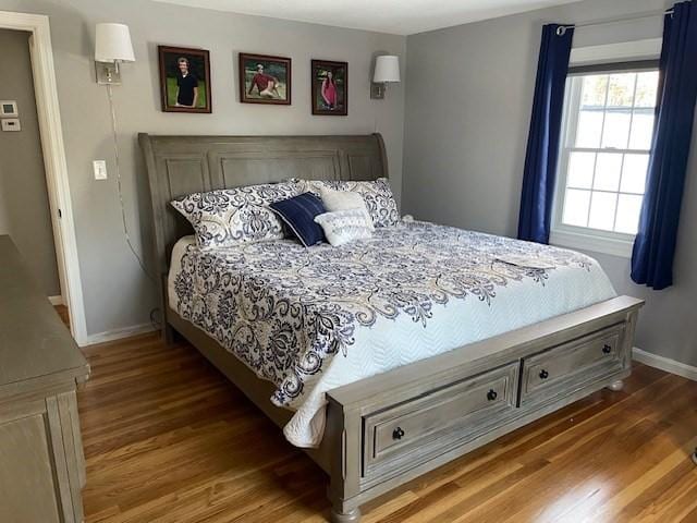 bedroom featuring baseboards and wood finished floors