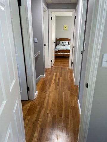 hall with wood finished floors