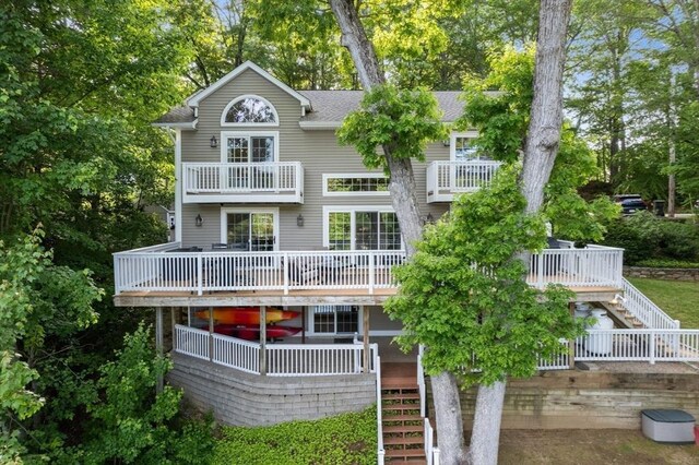 72 S Shore Dr, Sturbridge, MA 01566 - back of property featuring stairway, a balcony, a shingled roof, and view of scattered trees