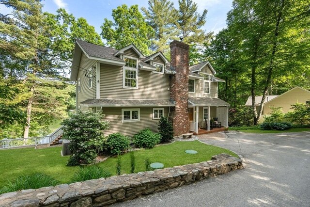 72 S Shore Dr, Sturbridge, MA 01566 - view of front of house featuring a porch, a chimney, asphalt driveway, and roof with shingles