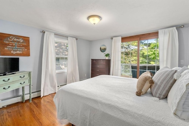72 S Shore Dr, Sturbridge, MA 01566 - bedroom featuring wood finished floors, a baseboard radiator, and a baseboard heating unit
