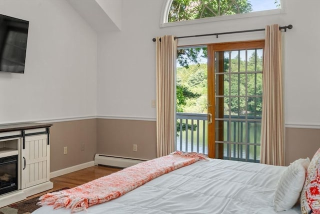 72 S Shore Dr, Sturbridge, MA 01566 - bedroom featuring a baseboard heating unit, wood finished floors, multiple windows, and access to outside
