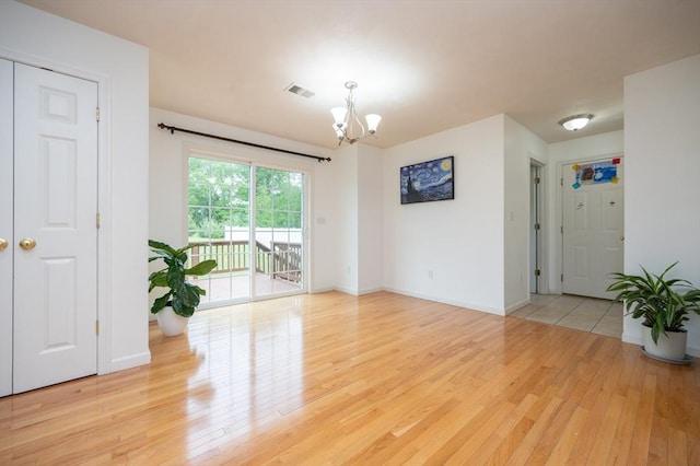 7 Willow Brook Ln, Blackstone, MA 01504 - empty room featuring a chandelier, light wood finished floors, and baseboards