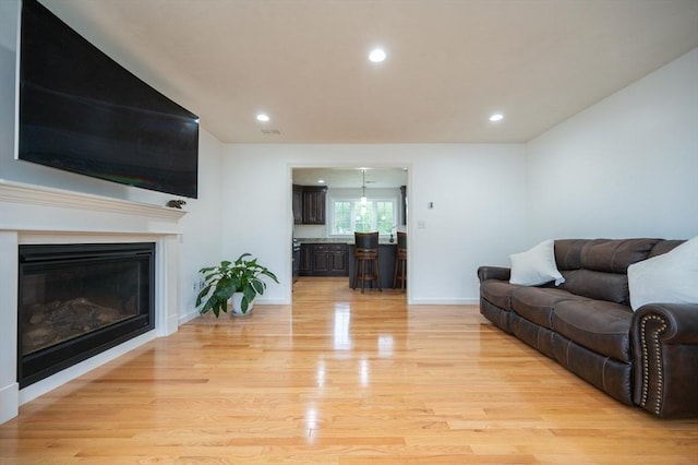7 Willow Brook Ln, Blackstone, MA 01504 - living room with light wood-style floors, a glass covered fireplace, recessed lighting, and baseboards