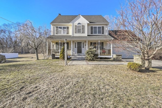 view of front of home featuring a front yard and covered porch