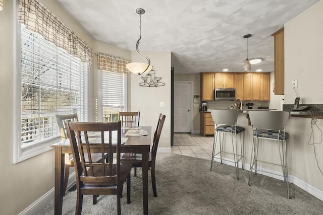 carpeted dining space featuring sink