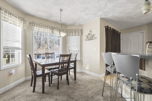 dining area featuring light colored carpet