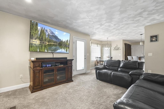 carpeted living room featuring a textured ceiling