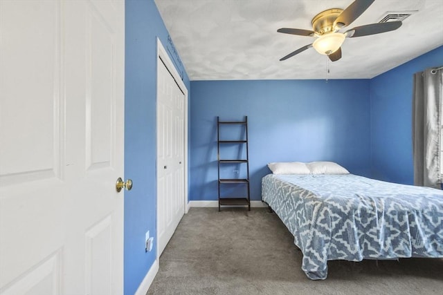 carpeted bedroom featuring ceiling fan and a closet