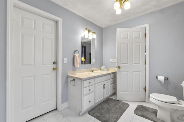 bathroom featuring vanity, lofted ceiling, and toilet