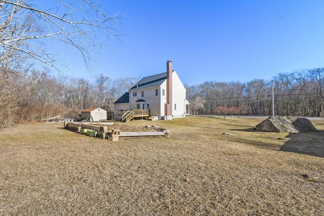 view of yard featuring an outbuilding and a deck