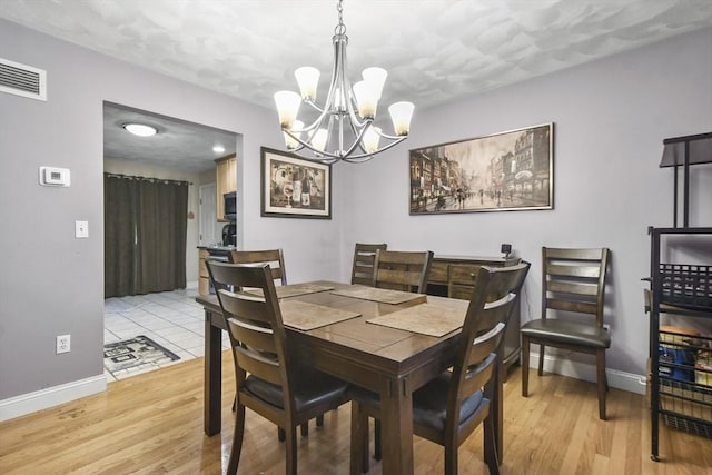 dining space featuring light wood-type flooring