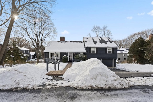 view of front of property with a chimney and an attached garage