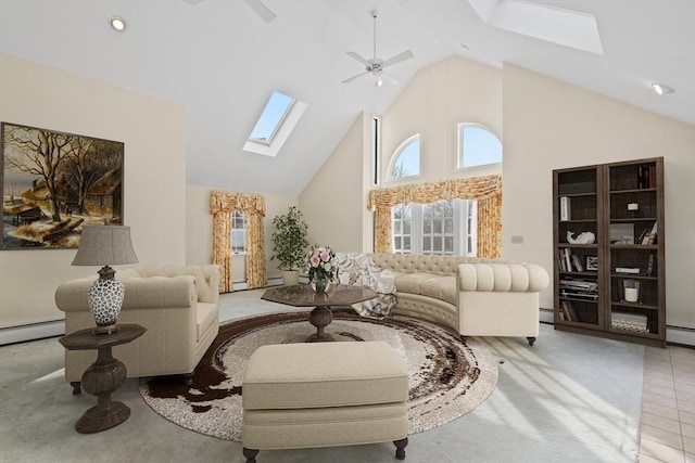 living area featuring a skylight, light tile patterned floors, a baseboard heating unit, ceiling fan, and high vaulted ceiling