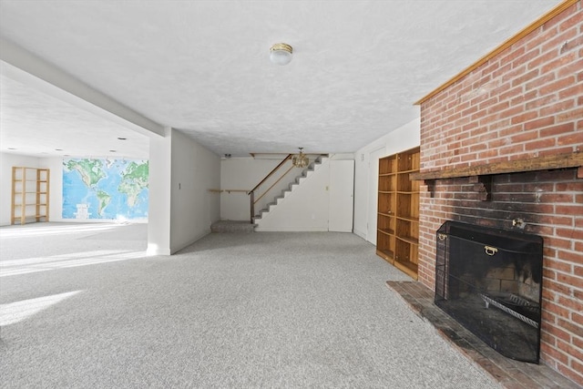 unfurnished living room with stairs, a fireplace, and a textured ceiling