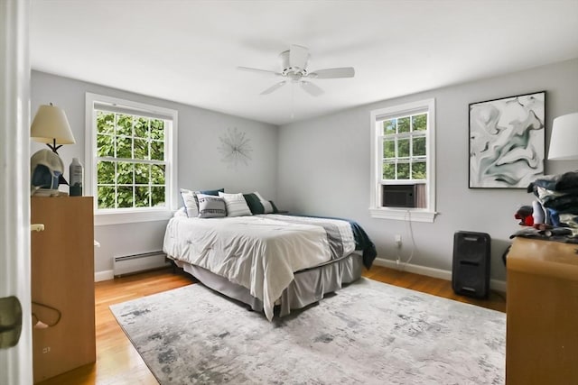 5 Fox Run Rd, Topsfield, MA 01983 - bedroom featuring a baseboard heating unit, wood finished floors, cooling unit, and ceiling fan