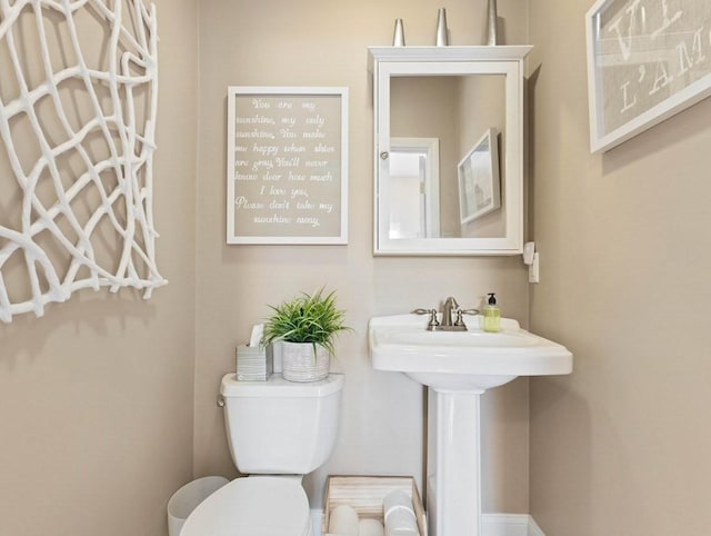 bathroom featuring sink and toilet