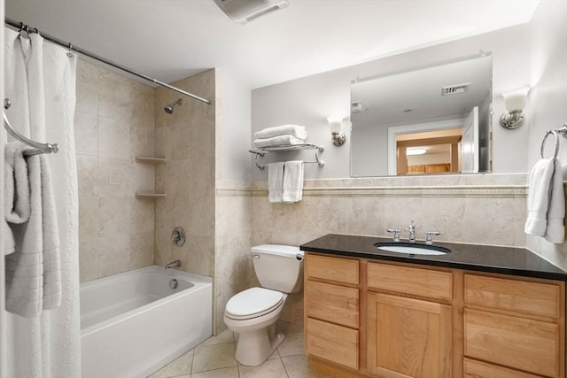 full bathroom with vanity, visible vents, tile patterned flooring, tile walls, and toilet