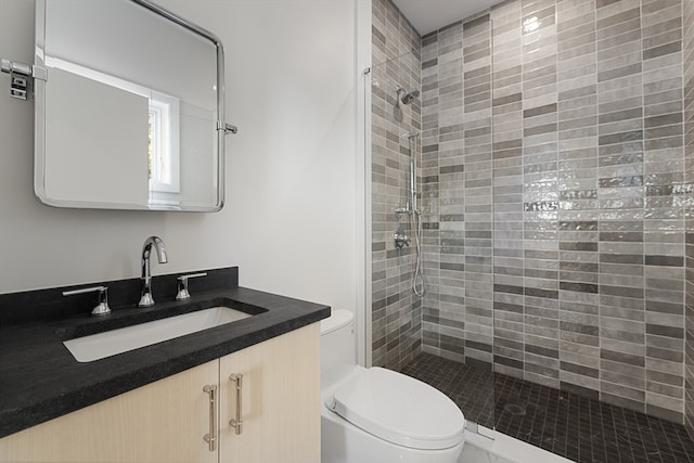 bathroom with walk in shower, vanity, and toilet