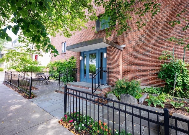25 Linden Ave Unit 4, Somerville, MA 02143 - entrance to property with brick siding, outdoor dining space, and a patio area