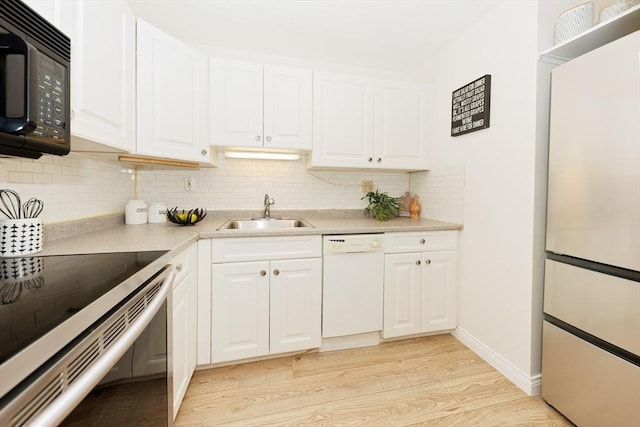 25 Linden Ave Unit 4, Somerville, MA 02143 - kitchen featuring white appliances, light wood finished floors, decorative backsplash, light countertops, and white cabinetry
