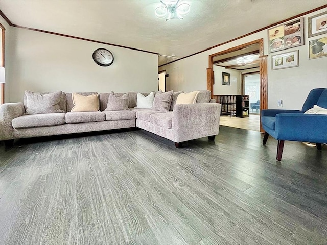 living area with crown molding and wood finished floors