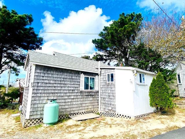 view of side of property with a storage shed