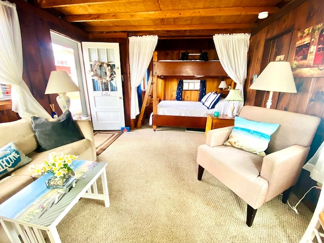 bedroom featuring carpet floors, beamed ceiling, and wood walls