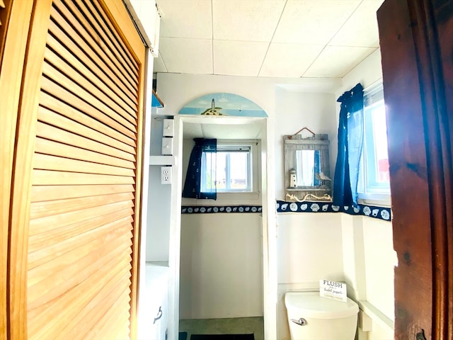 bathroom with ceiling fan, toilet, and tile patterned floors