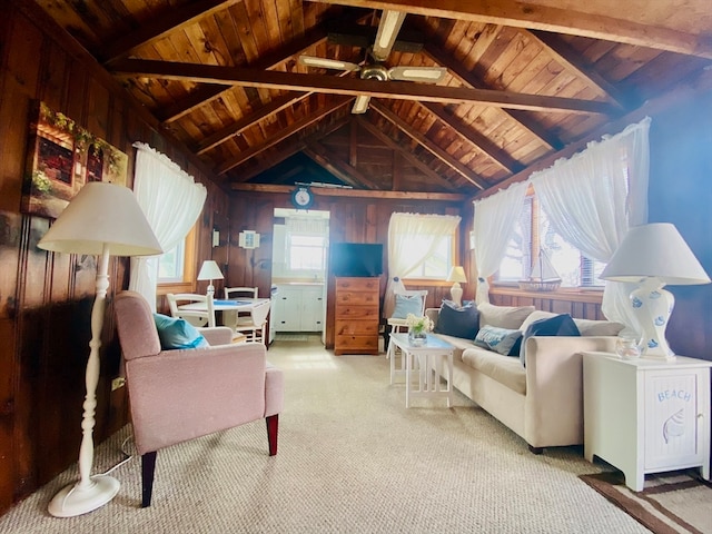 interior space with carpet floors, vaulted ceiling with beams, wooden walls, and a wealth of natural light