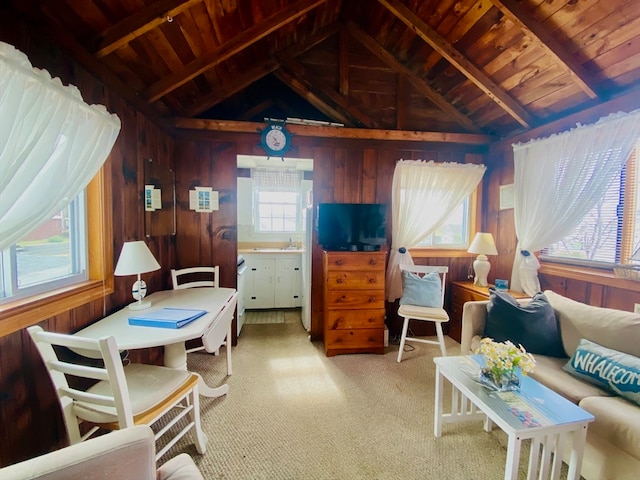 bedroom featuring lofted ceiling with beams, wooden walls, and wood ceiling